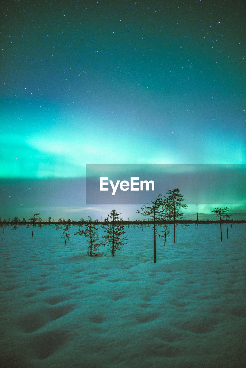 Scenic view of snow covered landscape against sky at night