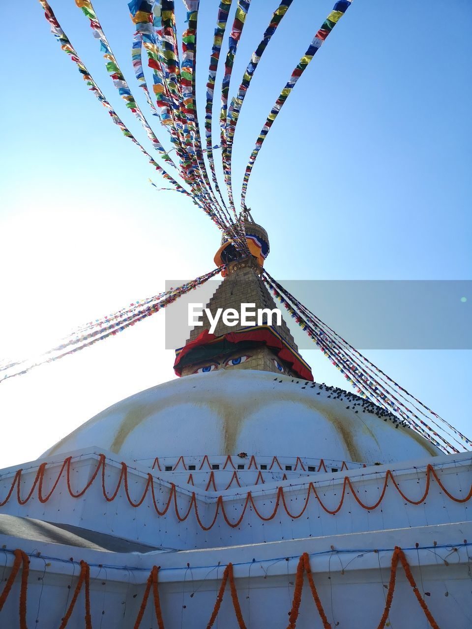 LOW ANGLE VIEW OF CAROUSEL AGAINST SKY