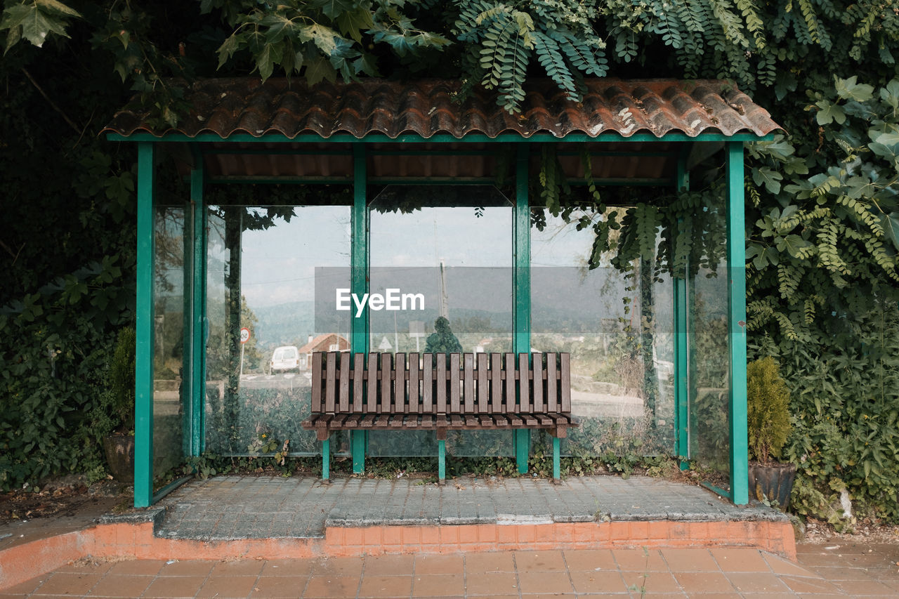 EMPTY BENCH BY BUILDING