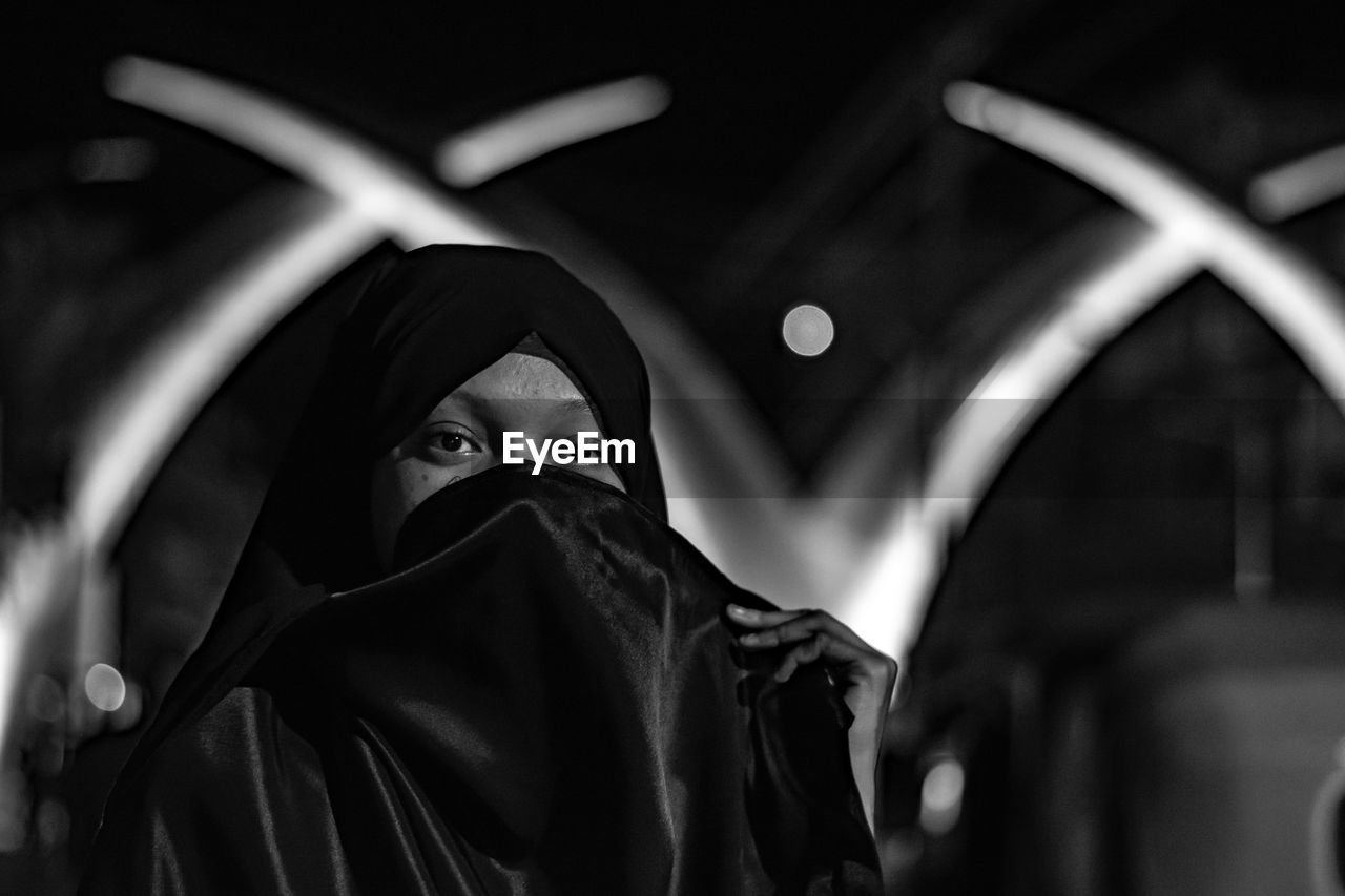 Portrait of woman wearing burka at night