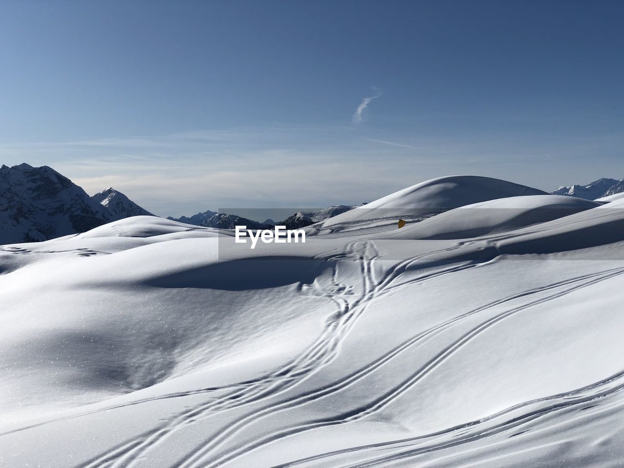 Scenic view of snow covered mountains against sky