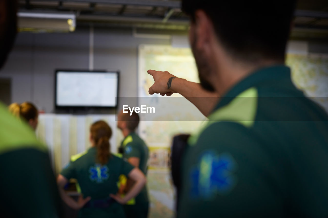 Male paramedic pointing on screen in hospital