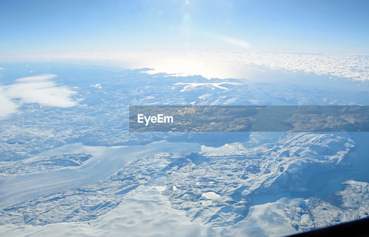 AERIAL VIEW OF SNOW COVERED LANDSCAPE
