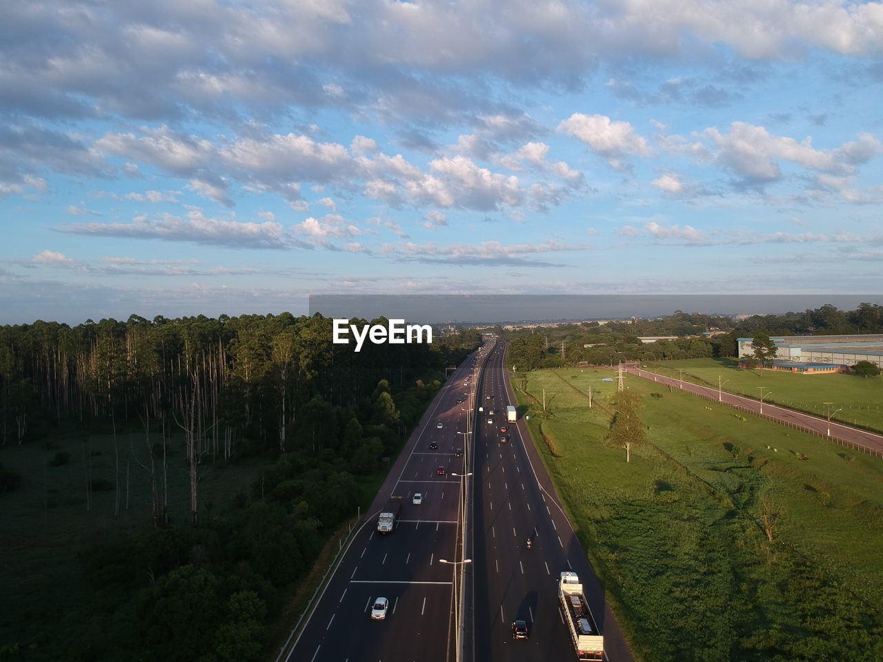 HIGH ANGLE VIEW OF ROAD IN CITY AGAINST SKY