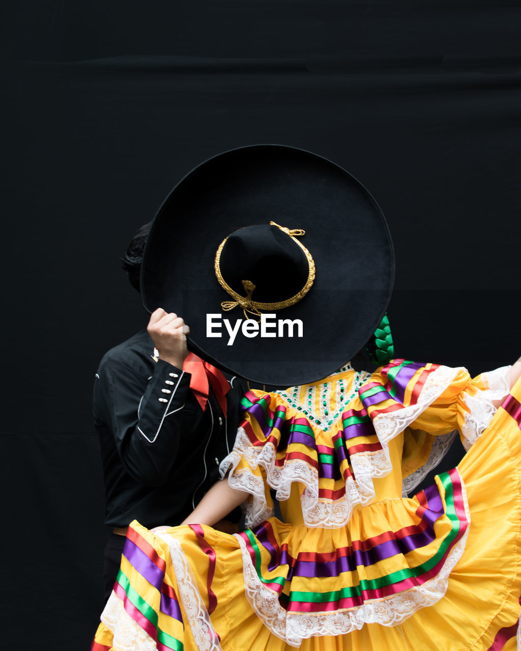 Dancers performing against black background