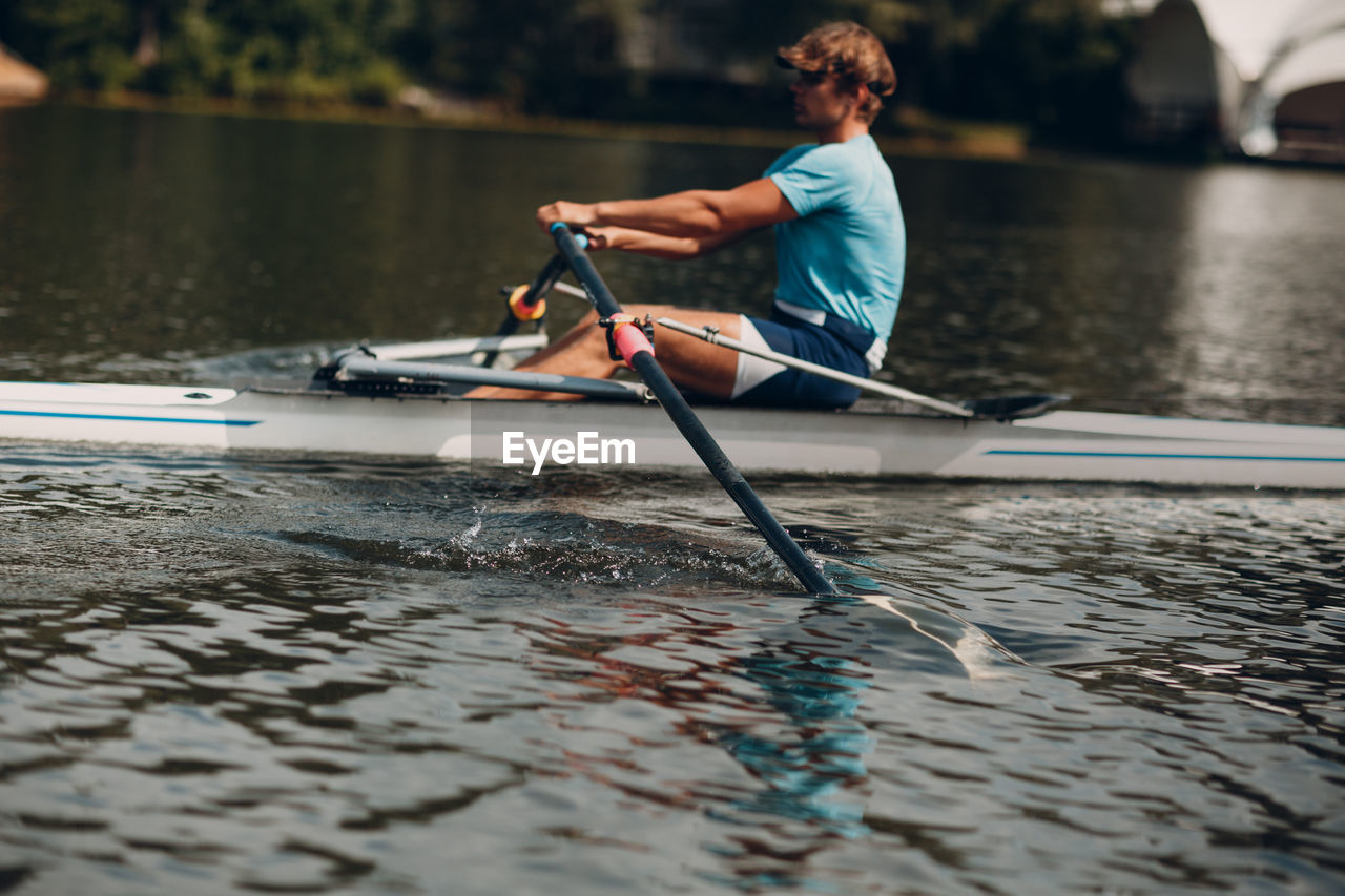 Man surfing on boat in lake