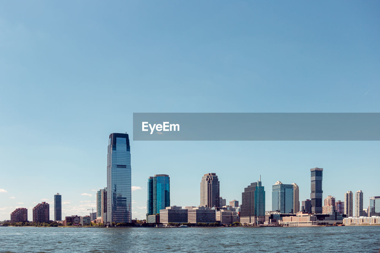 SEA AND BUILDINGS AGAINST CLEAR SKY