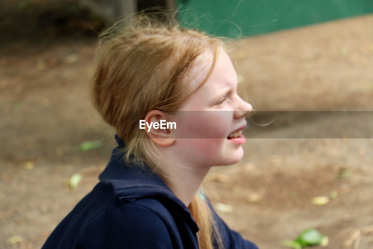 CLOSE-UP OF GIRL LOOKING AWAY