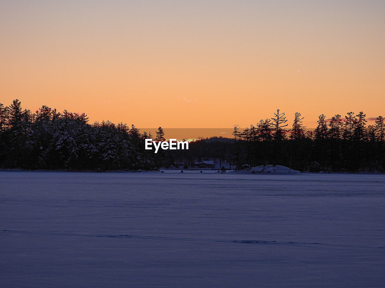 SNOW COVERED LANDSCAPE AGAINST SKY DURING SUNSET