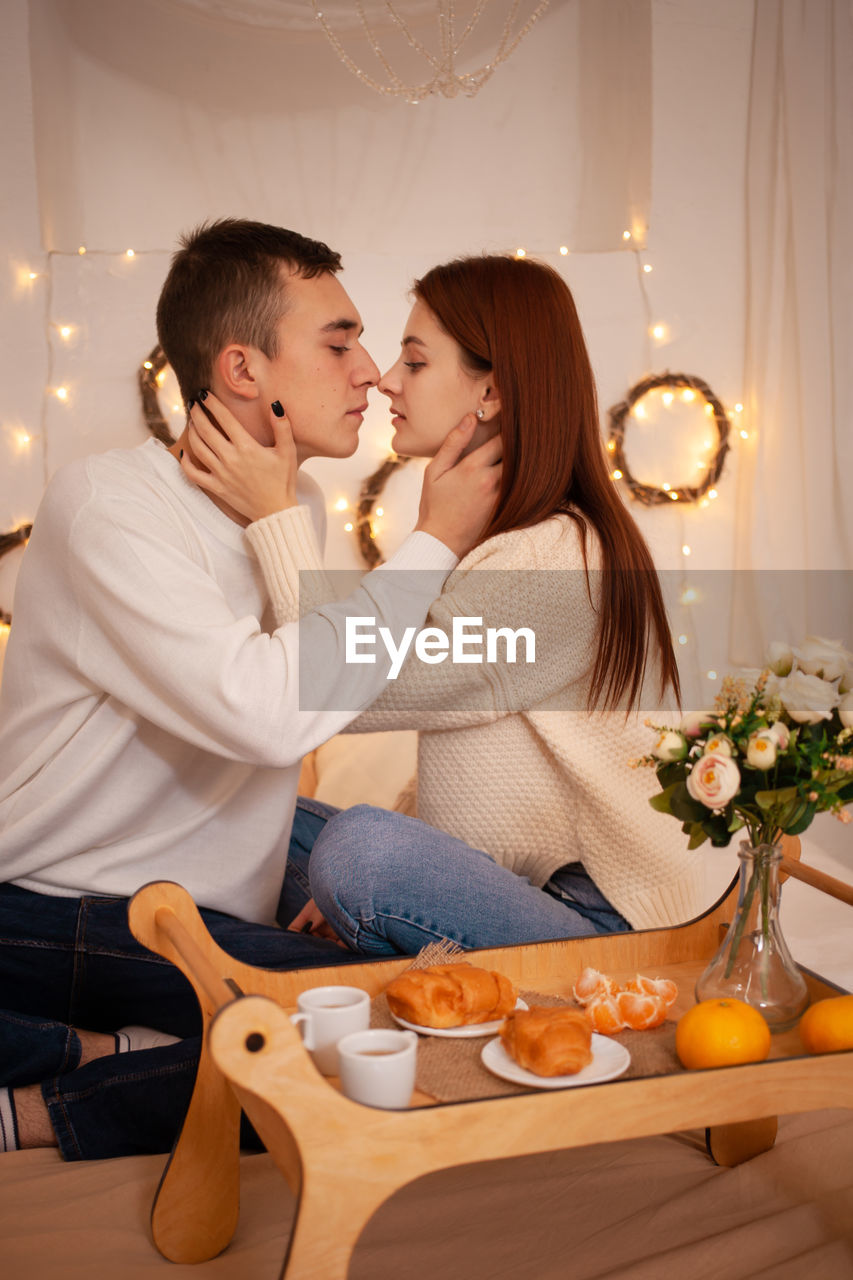 A young couple in love in a photo studio. christmas scenery, guy and girl love each other. 