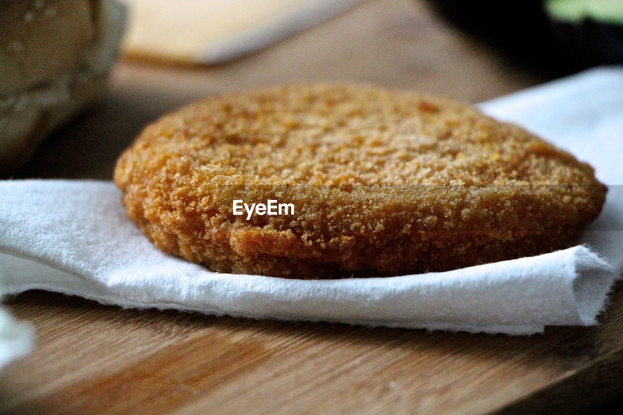 Close-up of chicken wing patty on tissue paper