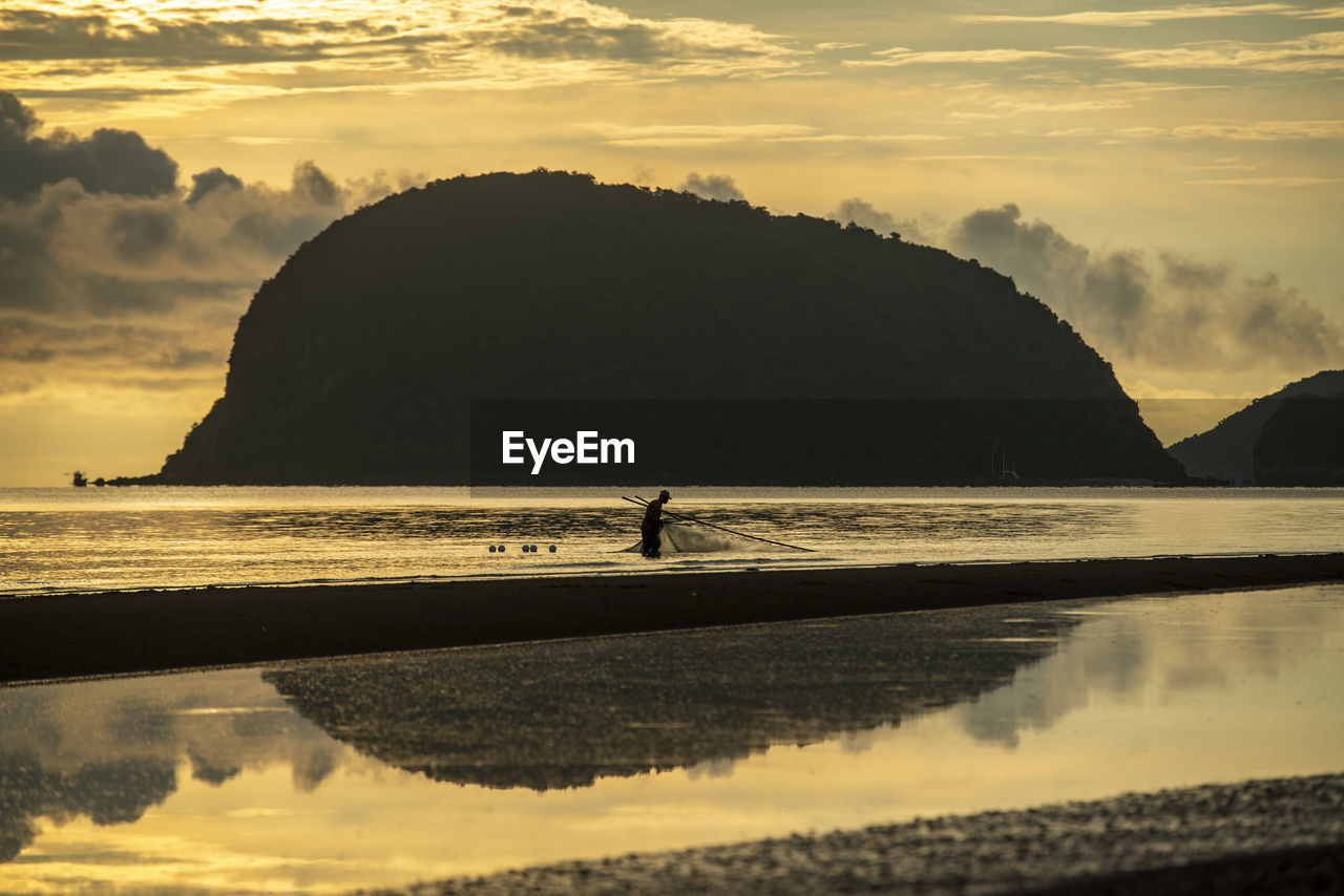 scenic view of sea against orange sky during sunset