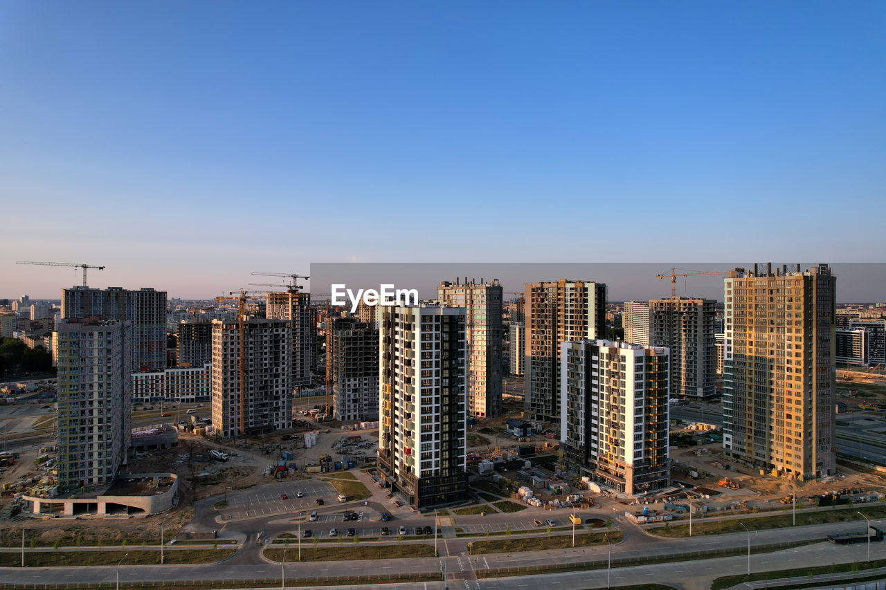 AERIAL VIEW OF CITY BUILDINGS AGAINST CLEAR SKY