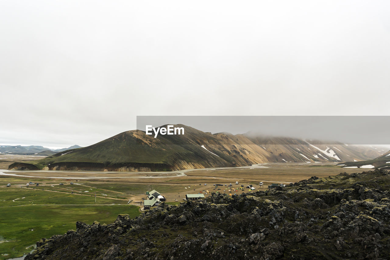 Icelandic landscape of landmannalaugar with camping site and huts for hikers and adventures