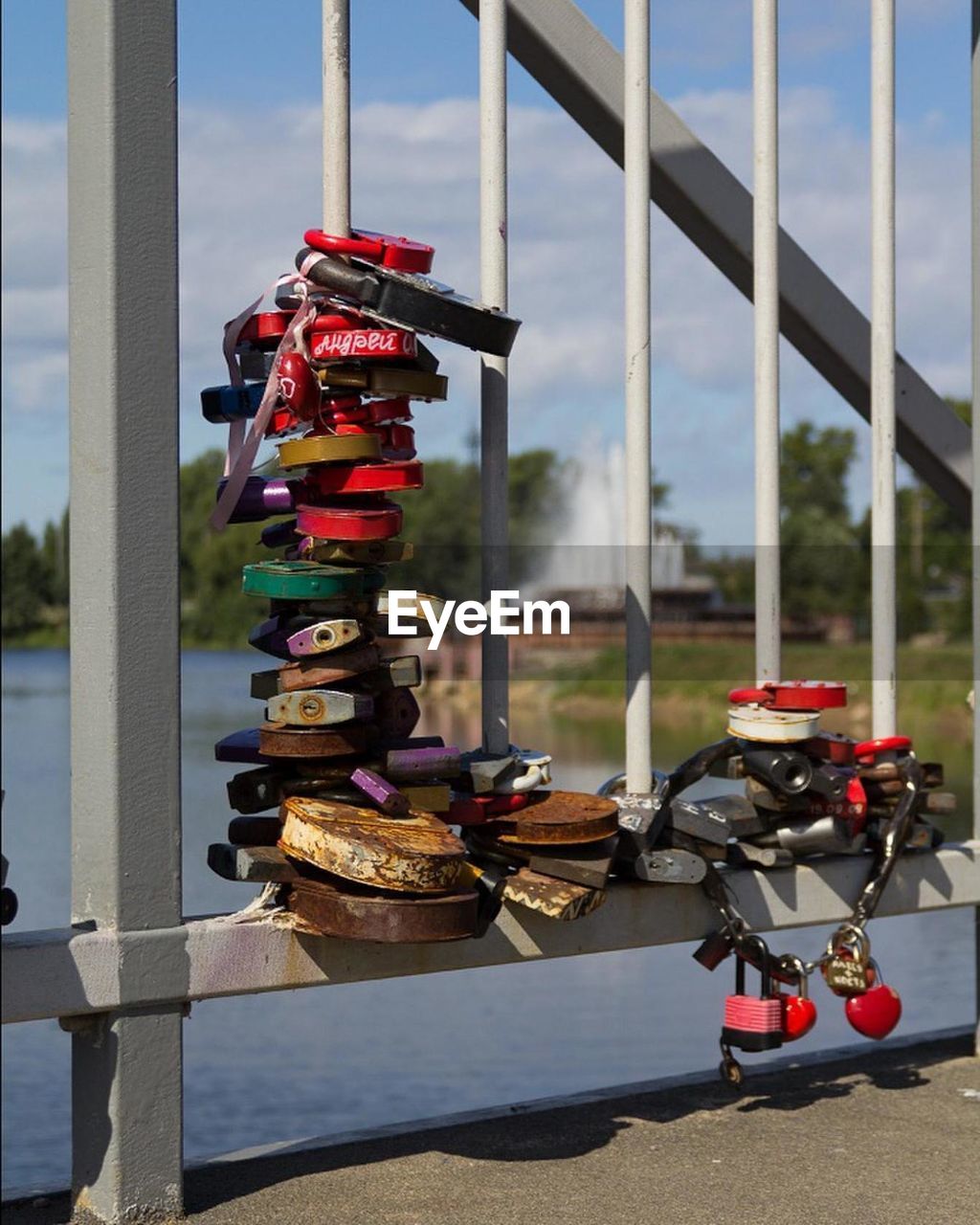 CLOSE-UP OF PADLOCKS HANGING ON METAL