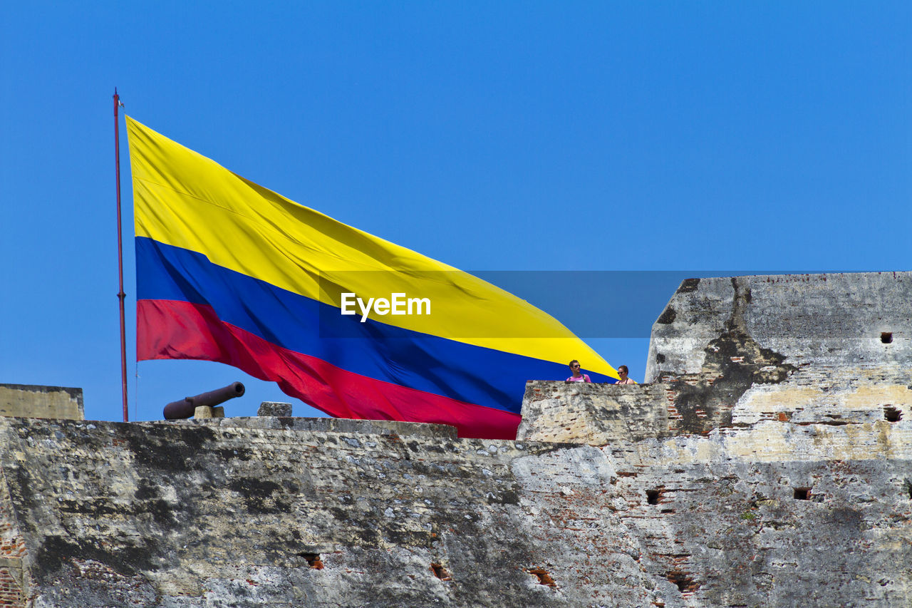 Low angle view of huge colombian flag flying over fortress