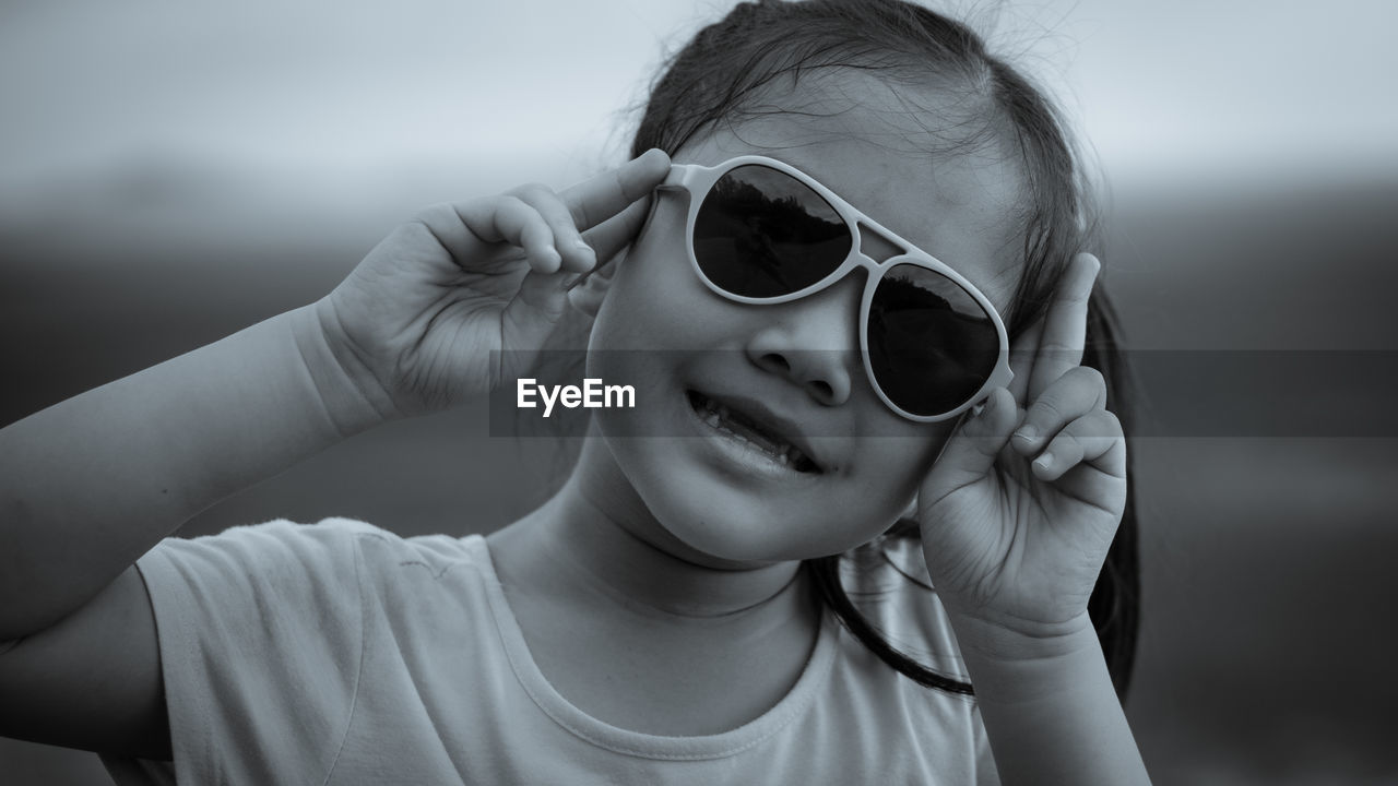 Portrait of smiling girl wearing sunglasses