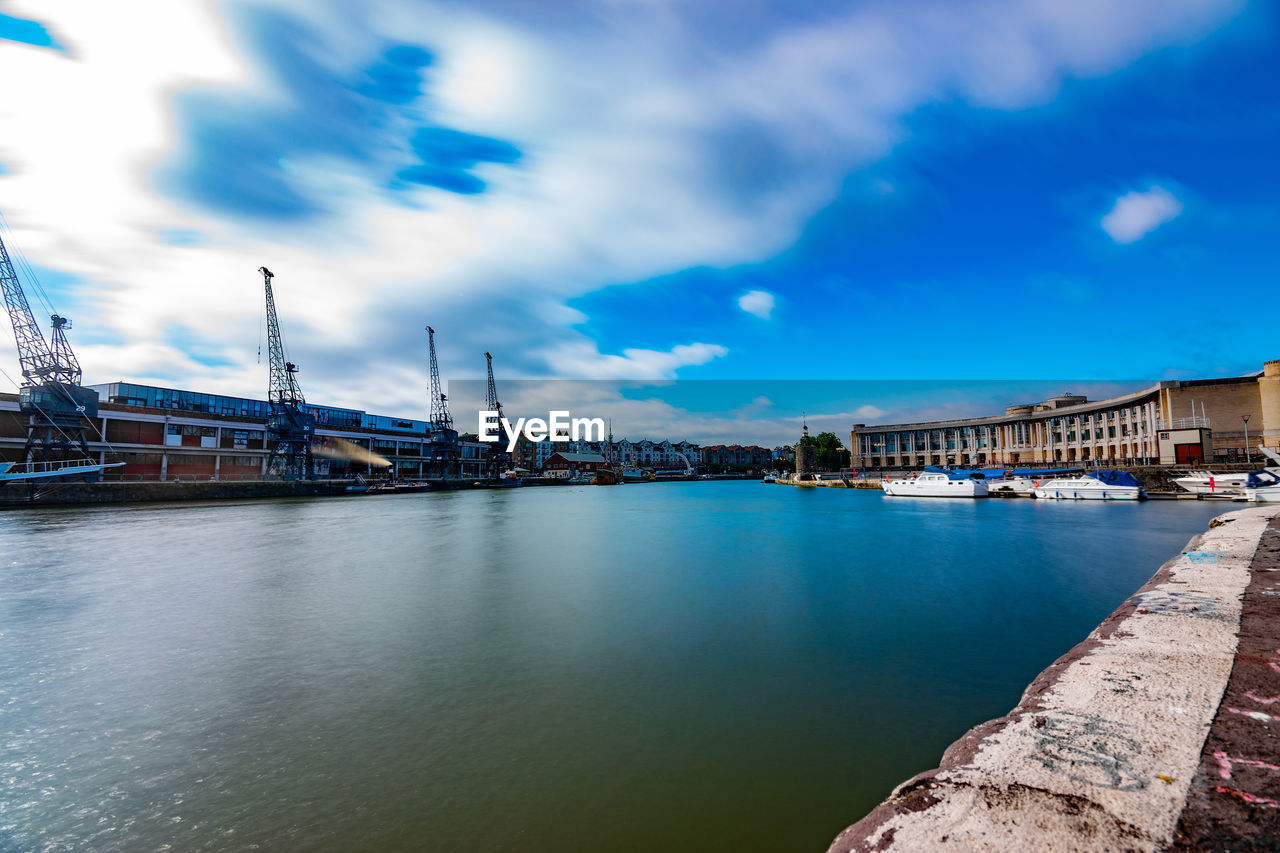 VIEW OF BRIDGE OVER RIVER AGAINST BUILDINGS