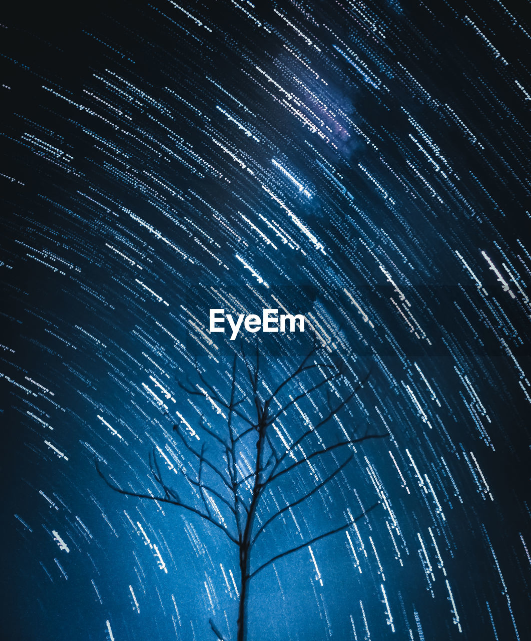 LOW ANGLE VIEW OF STAR TRAILS IN SKY