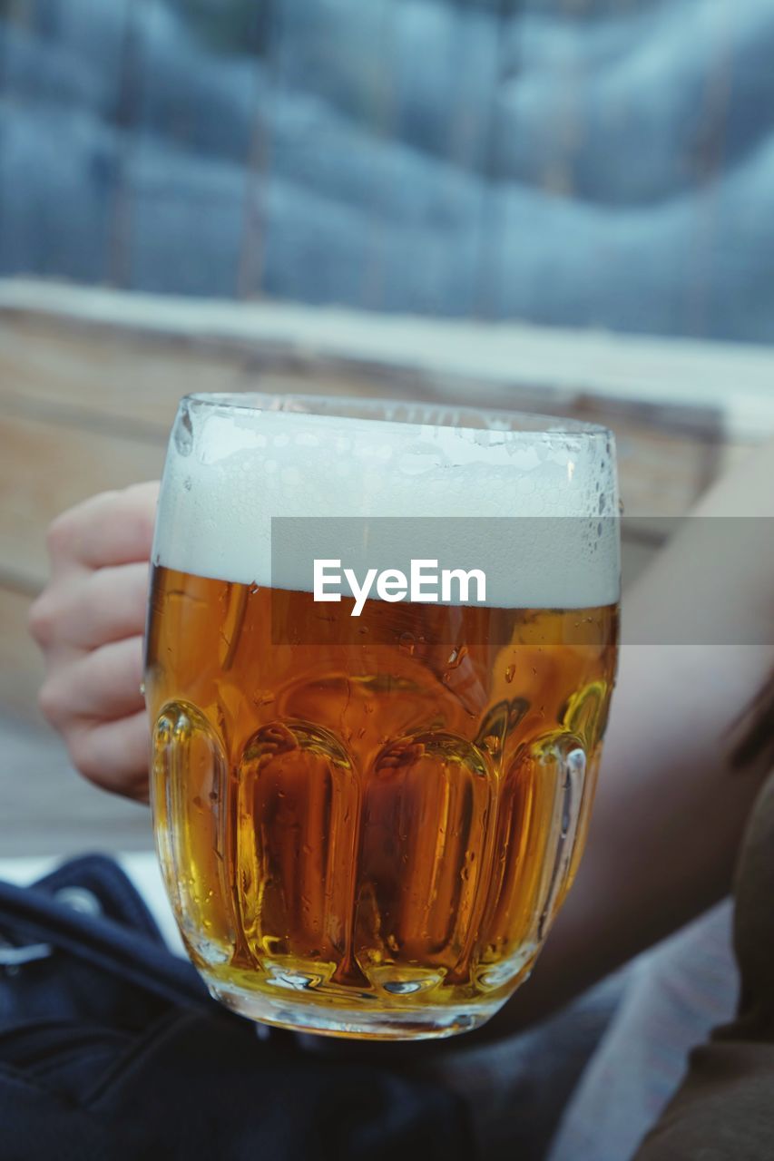 Cropped image of woman drinking beer