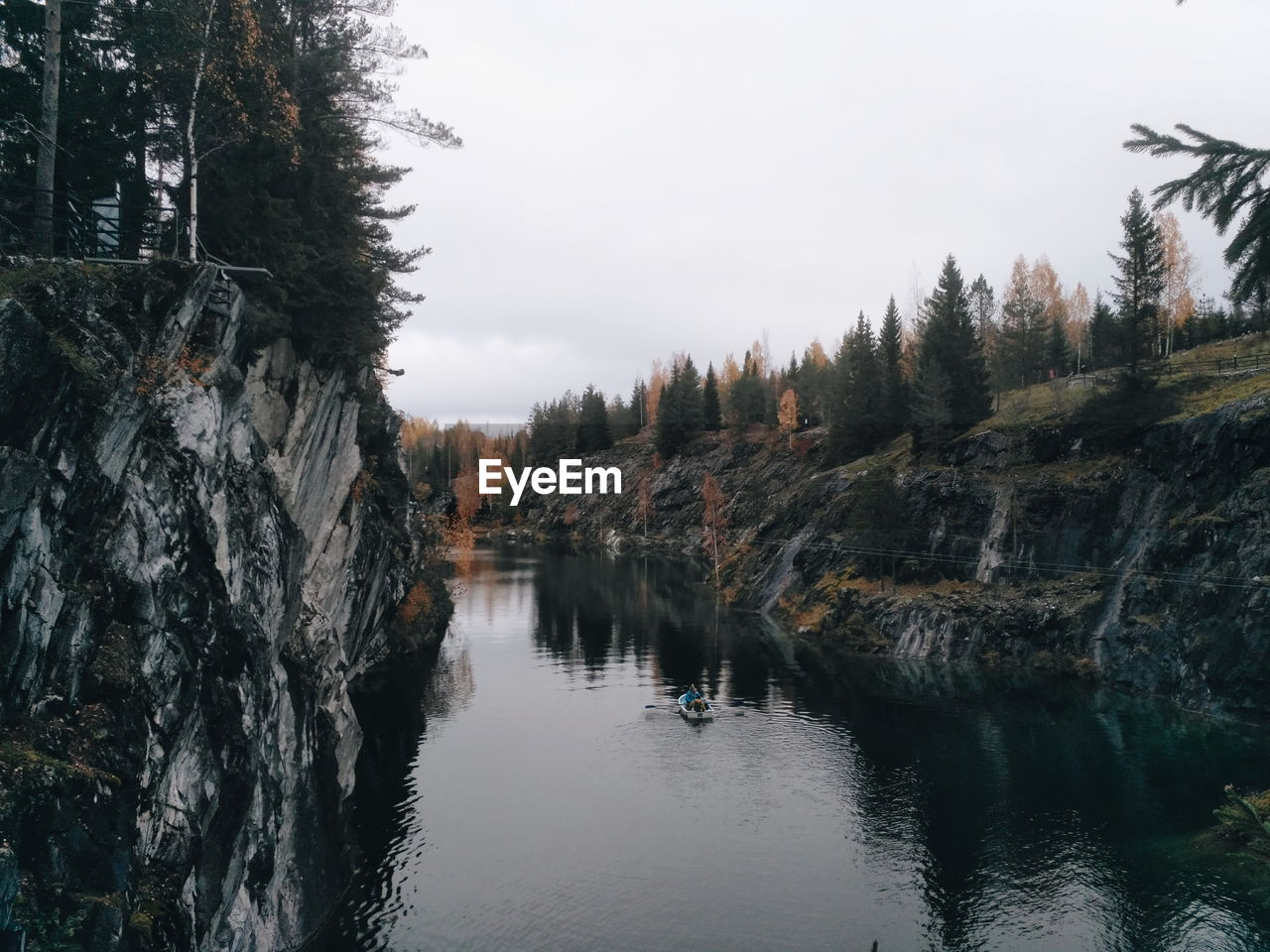 Panoramic shot of trees by lake against sky