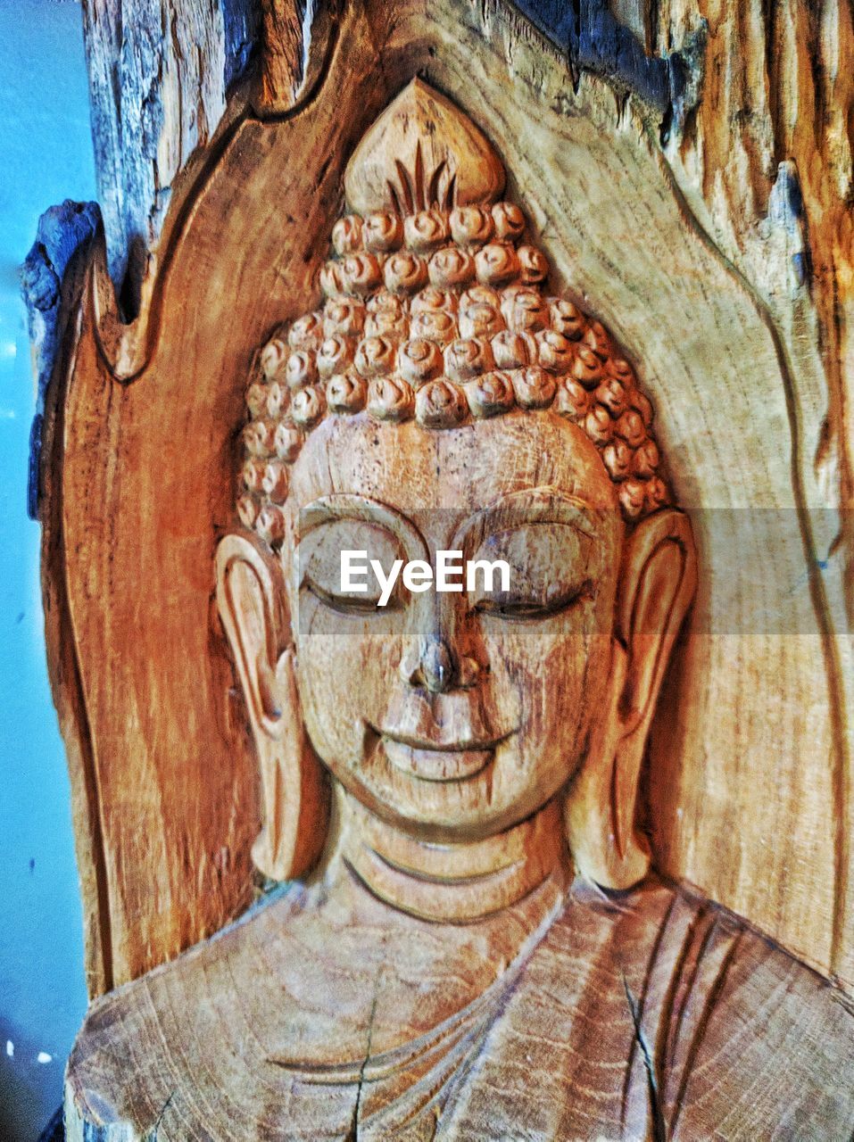 Close-up of buddha carving on wood