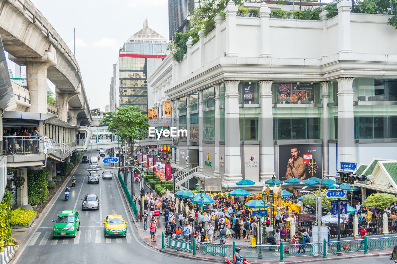 PEOPLE ON STREET AGAINST BUILDINGS