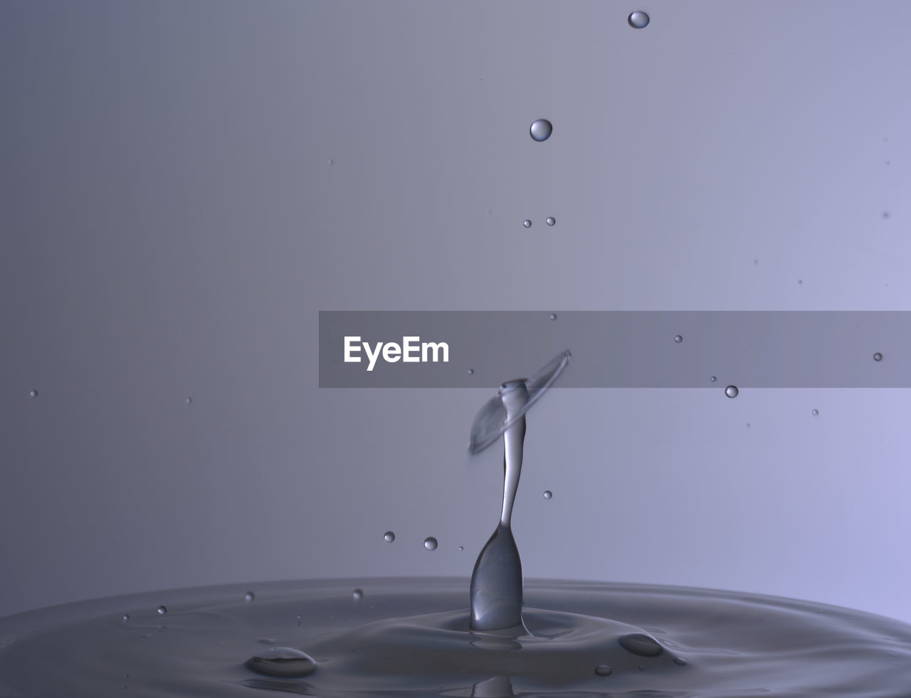 Close-up of water drop against gray background