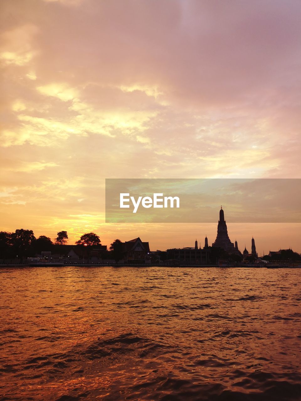 Silhouette of building against sky during sunset