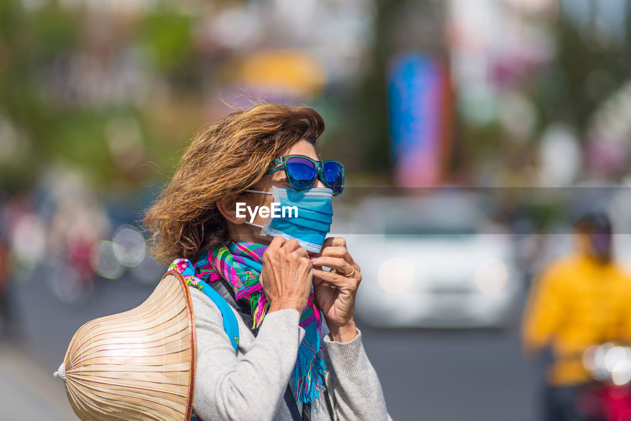 Portrait of woman wearing sunglasses standing outdoors