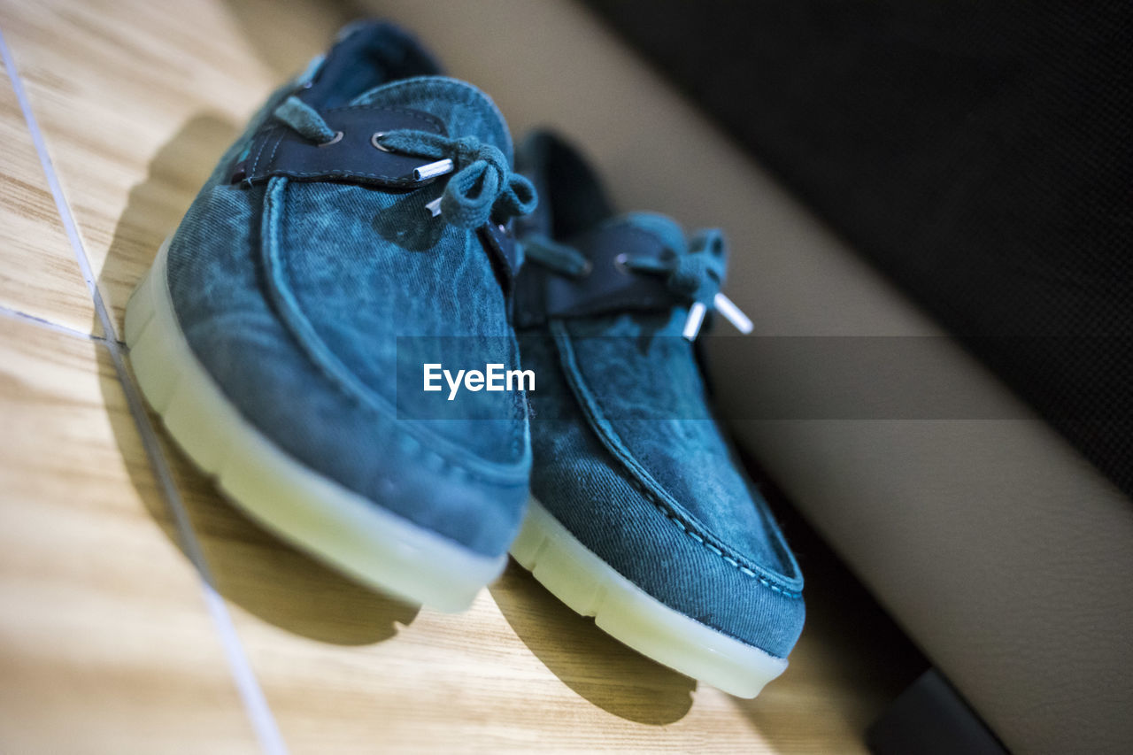 CLOSE-UP OF SHOES ON TABLE