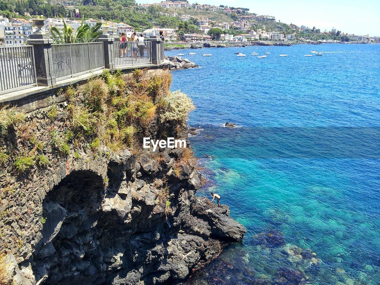 HIGH ANGLE VIEW OF ROCKS AND SEA