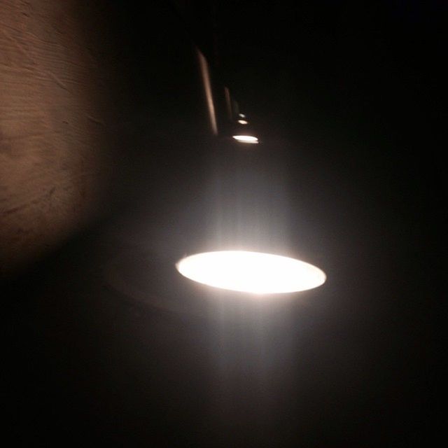 LOW ANGLE VIEW OF LIT LAMP HANGING ON CEILING