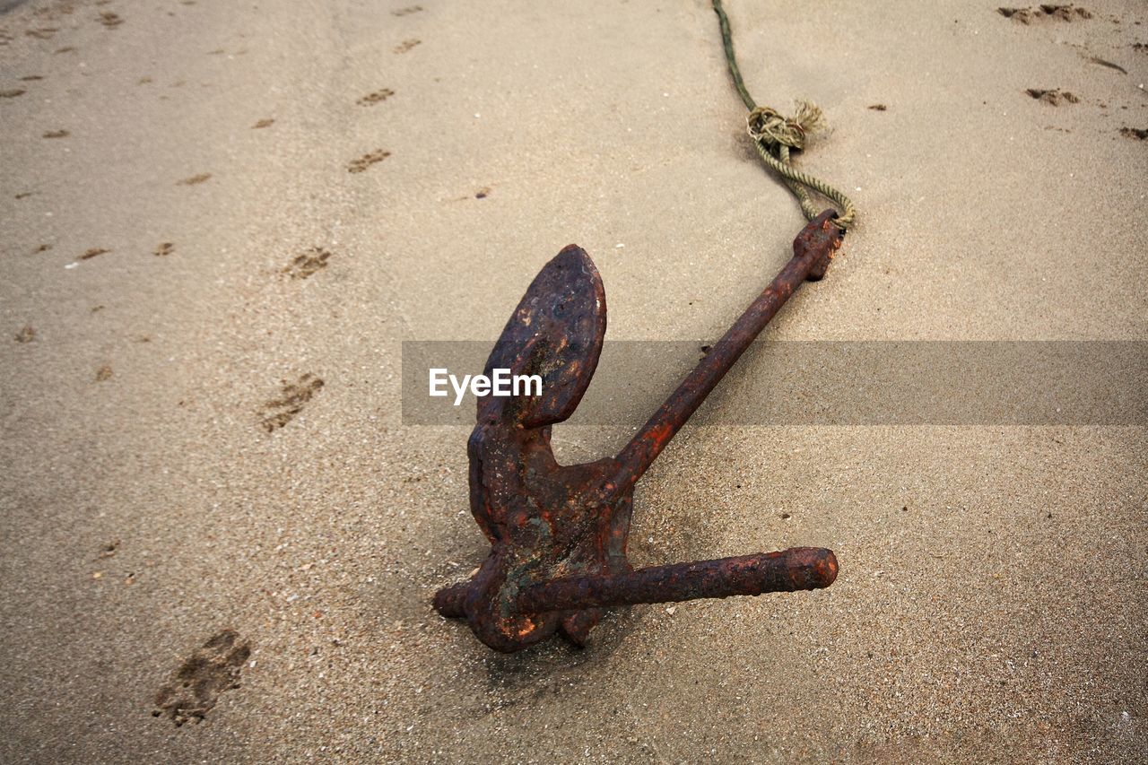 High angle view of rusty metal on sand