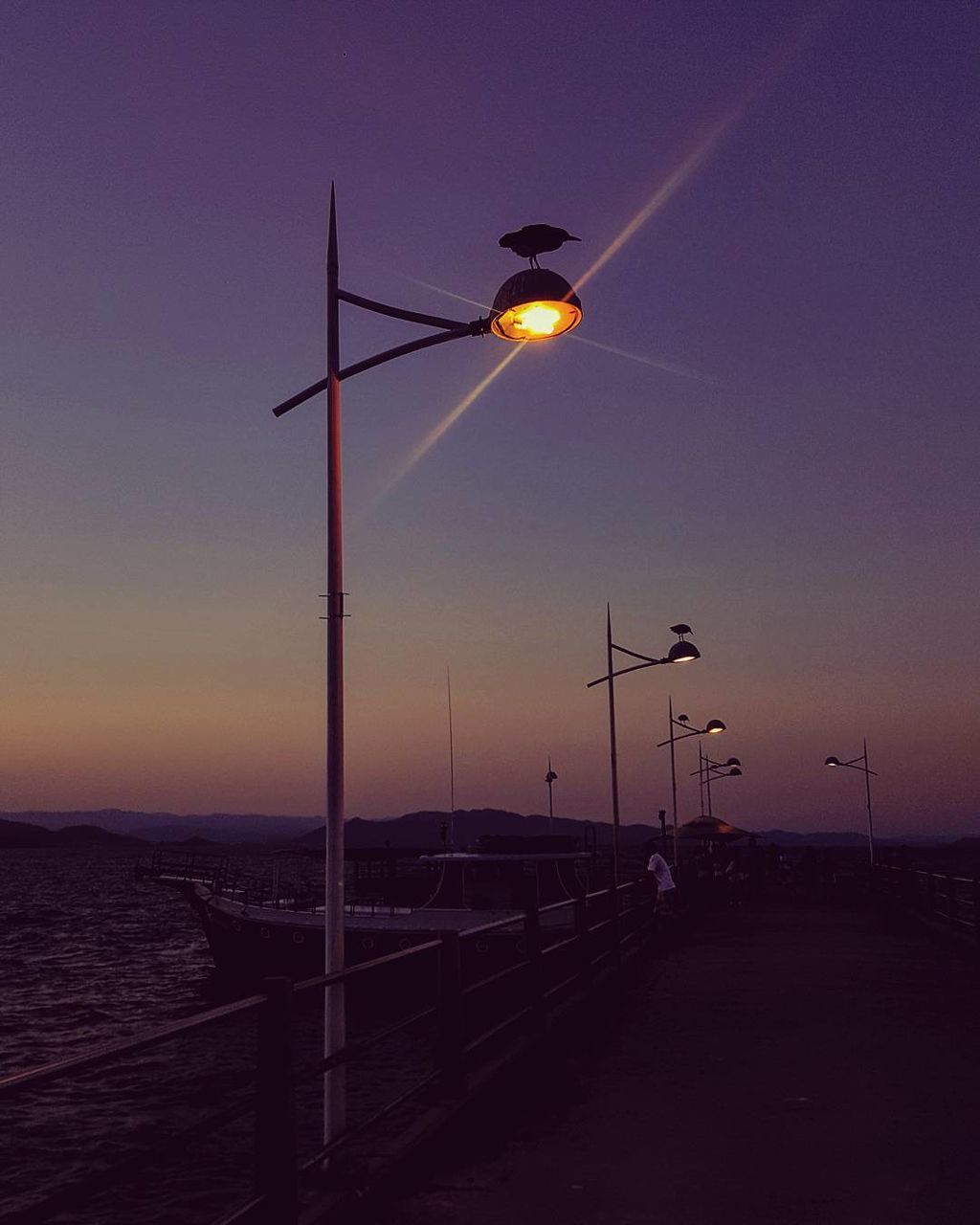 STREET LIGHTS AGAINST SKY AT NIGHT