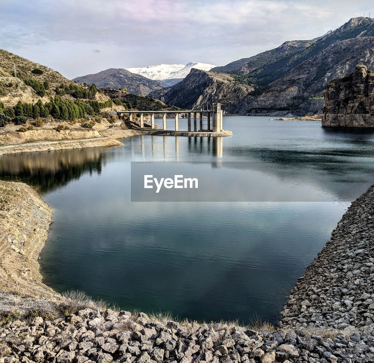 Scenic view of lake and mountains against sky