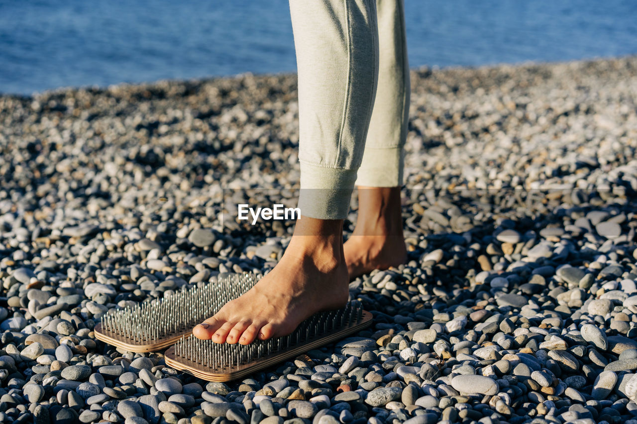 Close-up of a foot on a board with nails, spiritual practice of acupuncture and acupressure.