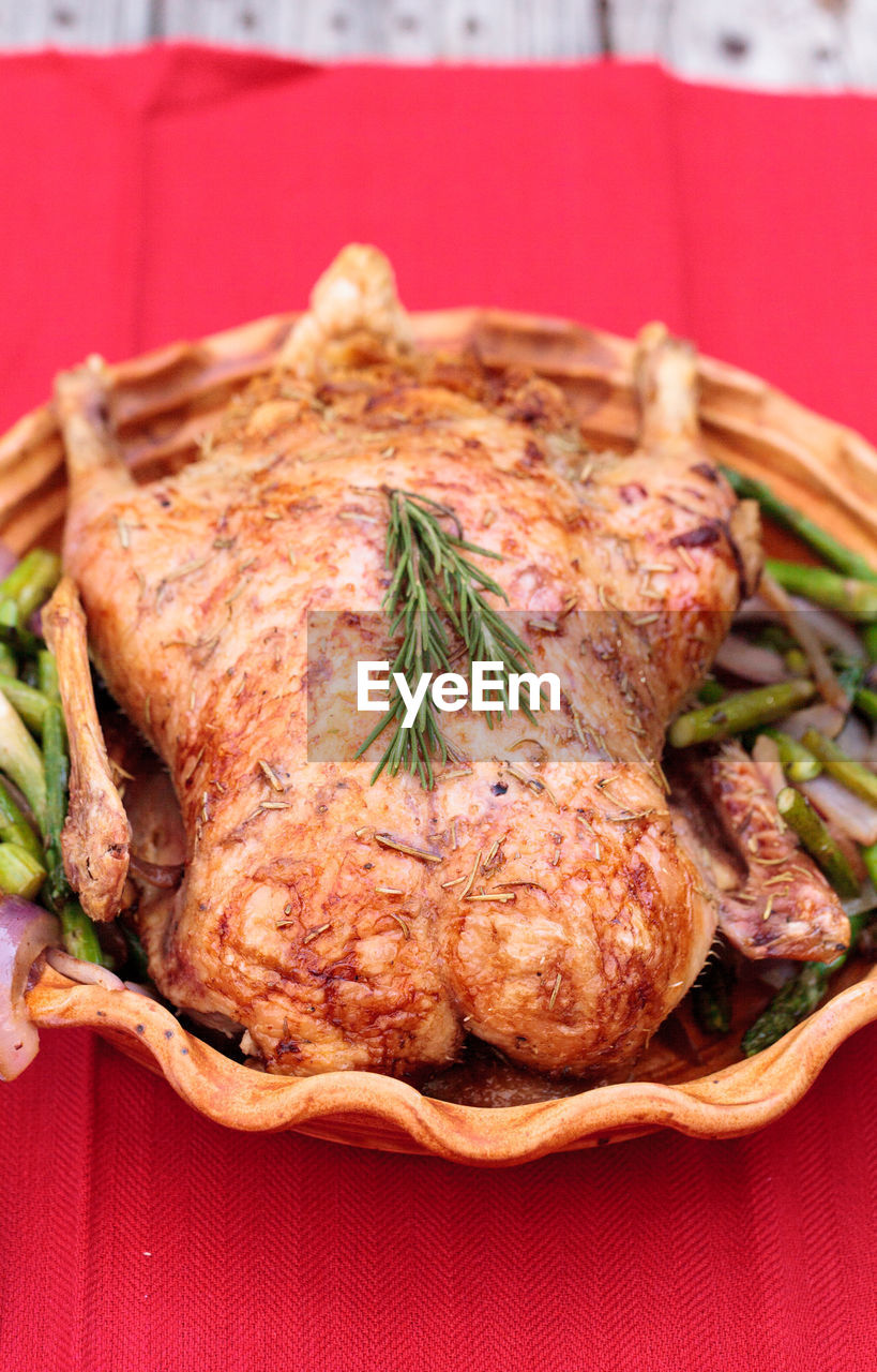 Close-up of roast chicken in container on table