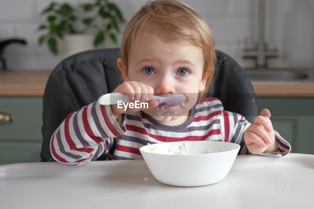 close-up of cute girl eating food at table