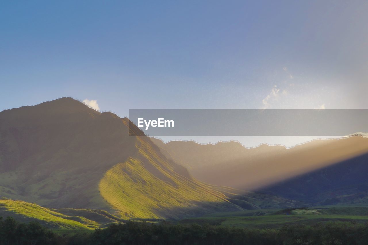 Scenic view of mountains against clear sky during sunset