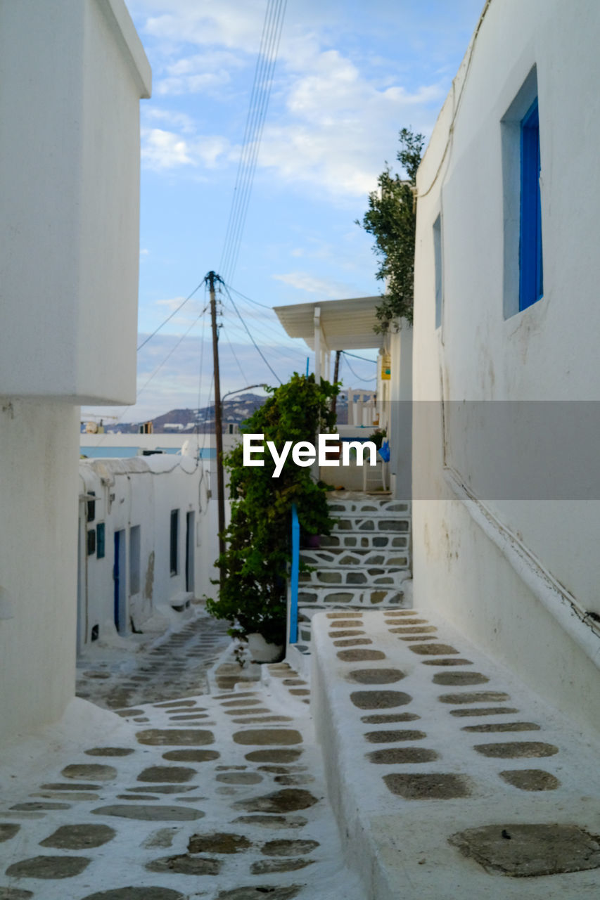 street amidst houses against sky