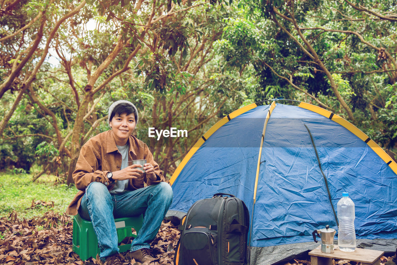 man sitting on tent