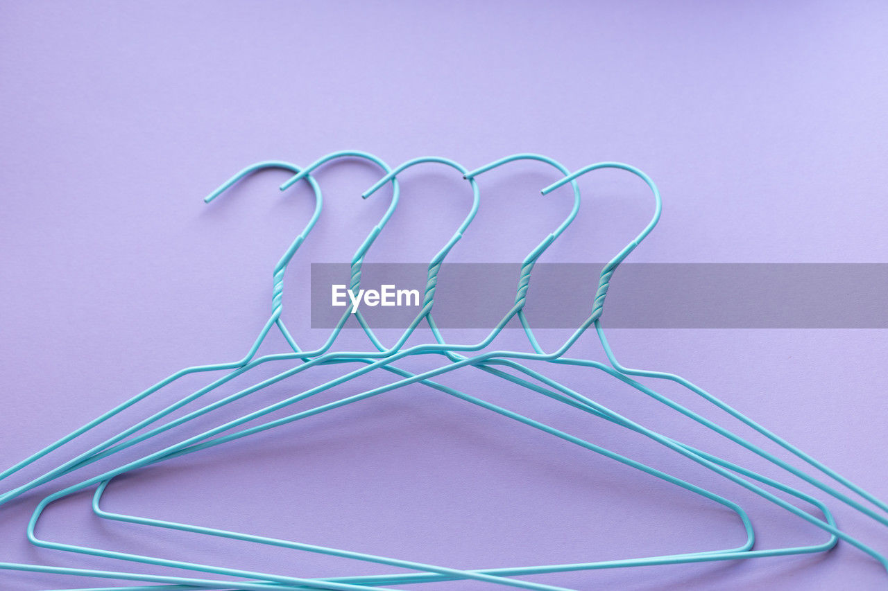 Hangers for clothes on purple background