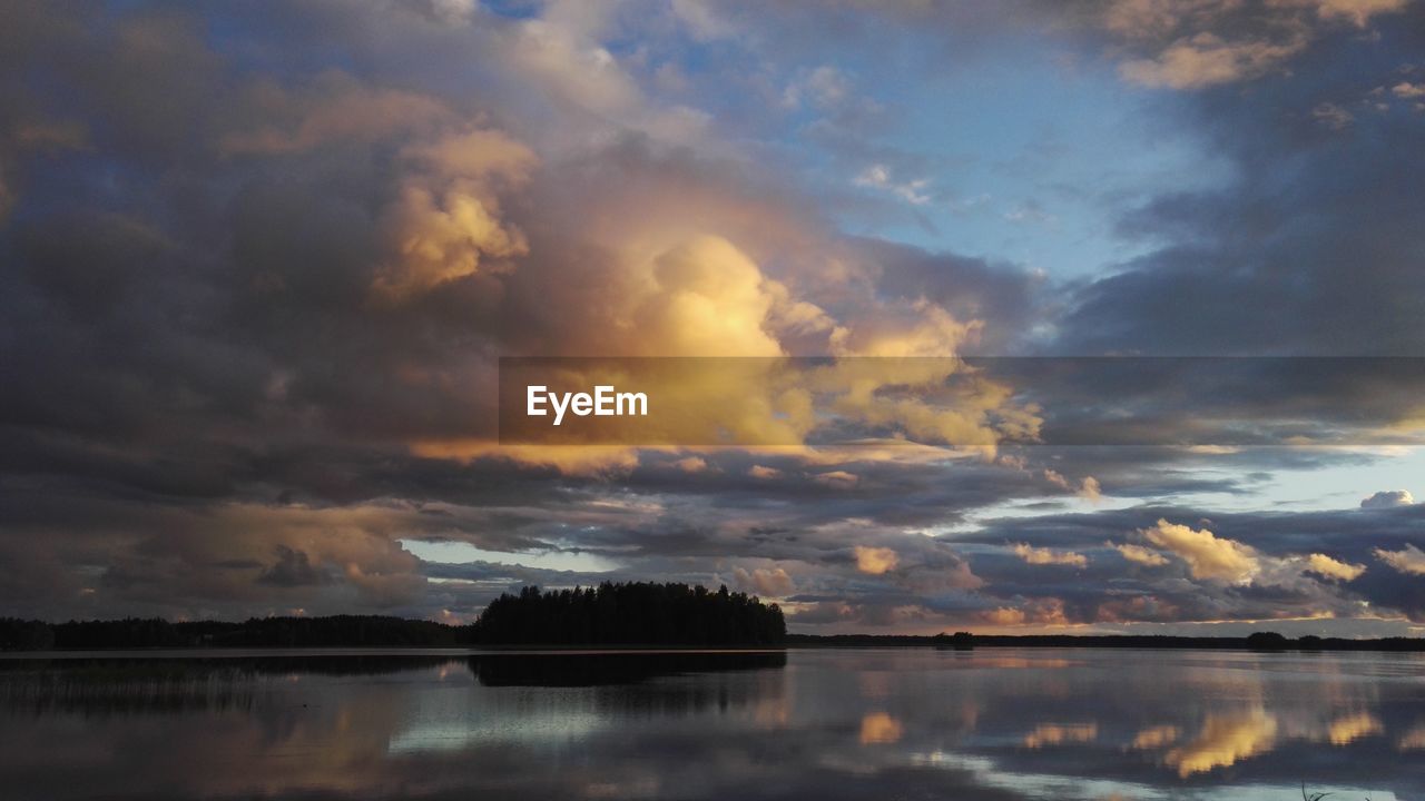 VIEW OF LAKE AGAINST CLOUDY SKY