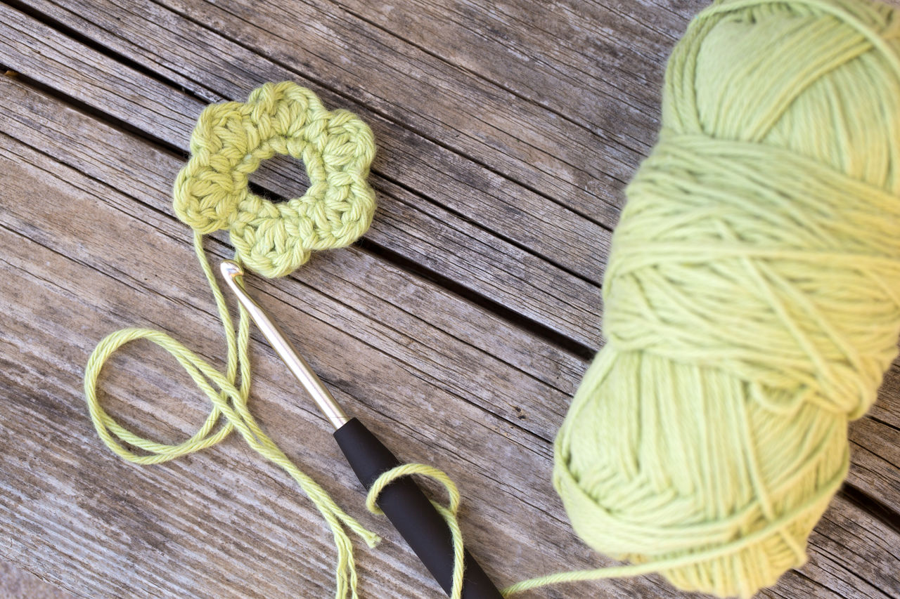 High angle view of wool with flower on table