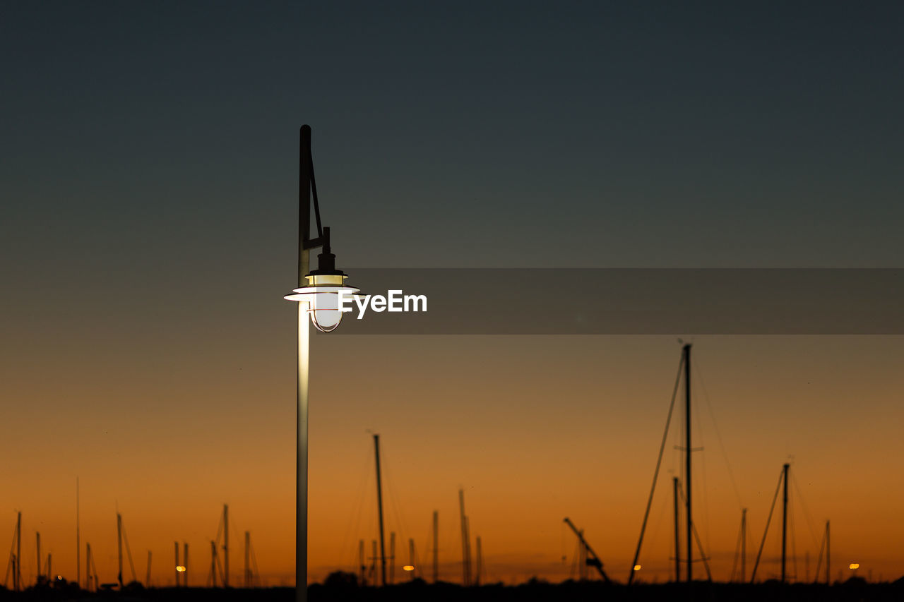 Street lamp against sky during sunset