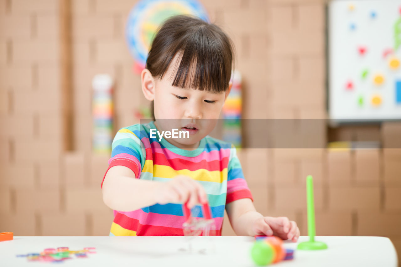 Young girl playing science experiment at home 