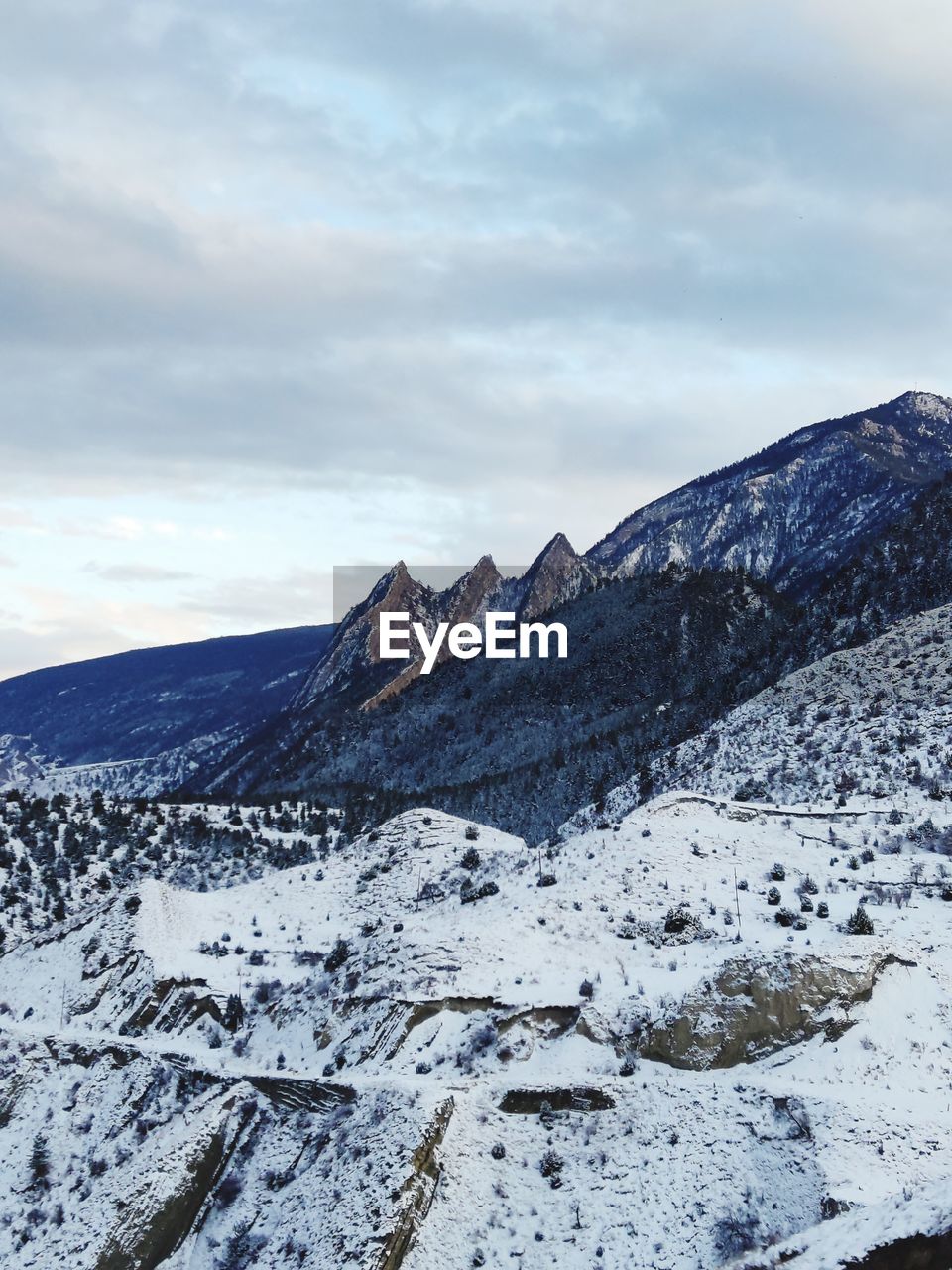winter, snow, mountain, environment, cold temperature, landscape, scenics - nature, sky, cloud, beauty in nature, mountain range, nature, ridge, snowcapped mountain, travel destinations, no people, travel, tranquility, tranquil scene, non-urban scene, plateau, land, summit, outdoors, wilderness, tourism, day, rock, extreme terrain, polar climate, frozen, remote, overcast, idyllic