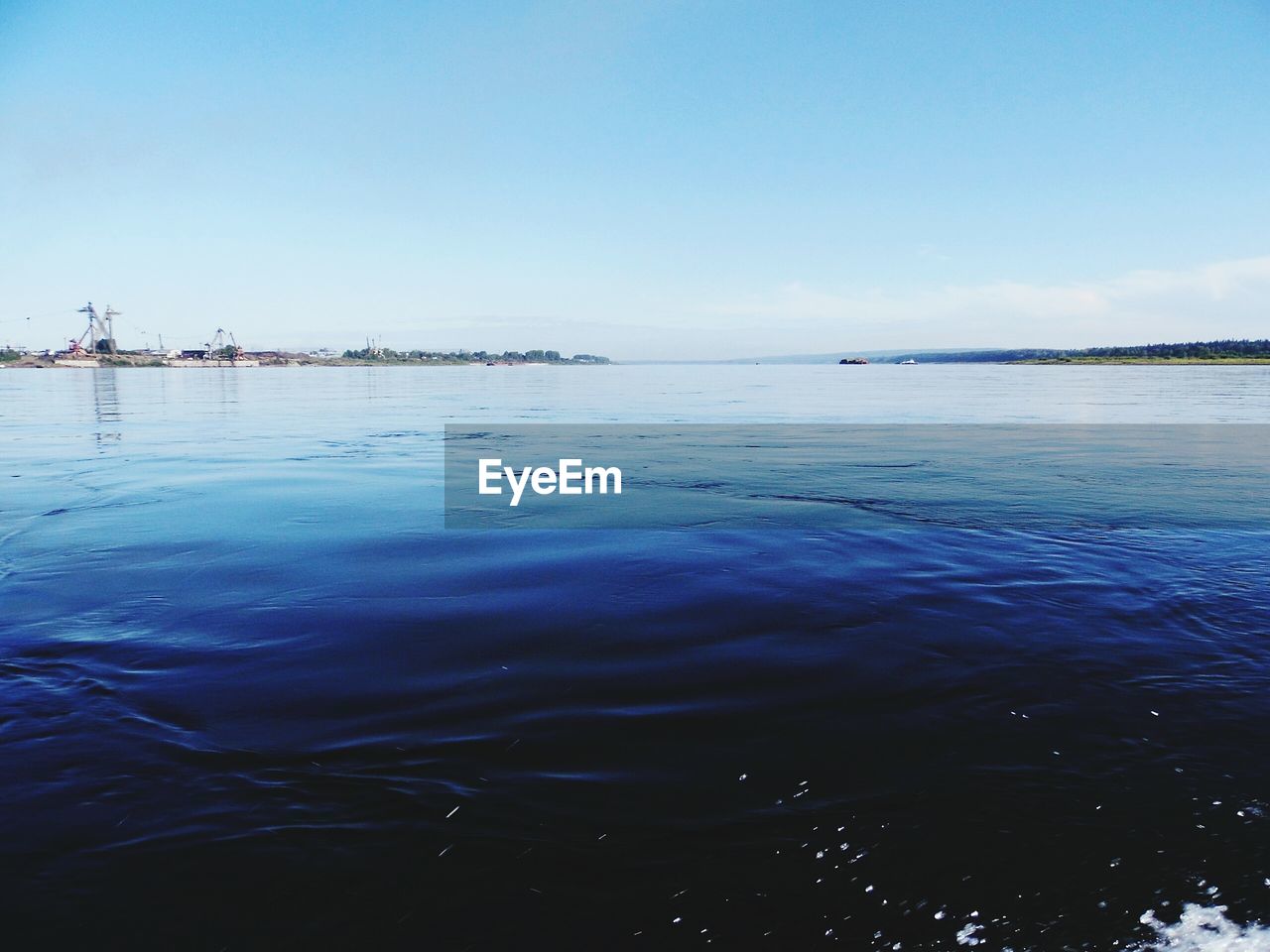 Scenic view of sea against blue sky