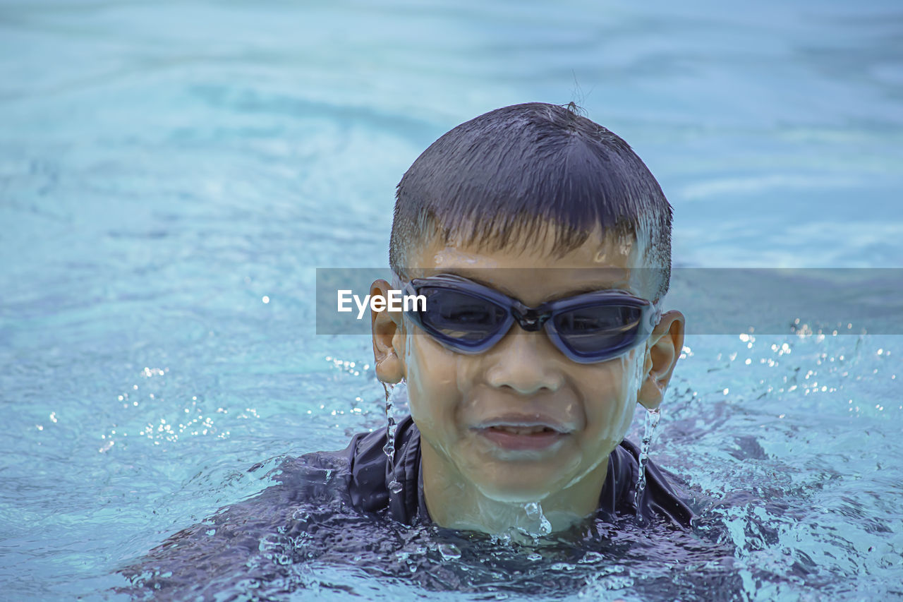 Portrait of boy swimming in pool